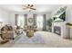 Bright living room with fireplace, decorative curtains, and comfortable seating area at 625 St Annes Pl, Covington, GA 30016