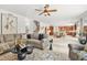 Spacious living room open to kitchen, with a sectional sofa and a ceiling fan at 625 St Annes Pl, Covington, GA 30016