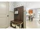 Mud room features a storage bench with a view of the kitchen at 625 St Annes Pl, Covington, GA 30016