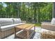 Outdoor seating area on deck with view of backyard and forest at 625 St Annes Pl, Covington, GA 30016