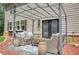 Cozy outdoor patio with wicker seating and a pergola, perfect for relaxing and entertaining at 625 St Annes Pl, Covington, GA 30016
