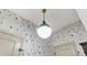 Stylish powder room with crane patterned wallpaper and modern lighting at 625 St Annes Pl, Covington, GA 30016