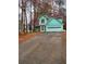 Exterior of a two-story green house with a driveway at 1034 Bettina Sw Ct, Mableton, GA 30126