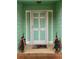 Charming front door with decorative plants and green exterior at 1034 Bettina Sw Ct, Mableton, GA 30126
