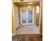 Hallway with double French doors, tile flooring, and yellow walls at 1034 Bettina Sw Ct, Mableton, GA 30126