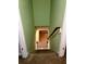 Carpeted staircase leading downstairs with a wooden railing and light green walls at 1034 Bettina Sw Ct, Mableton, GA 30126