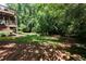 View of backyard with wooden deck on house in background at 7030 Wessex Way, Cumming, GA 30028