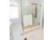 Modern bathroom showcasing a glass-enclosed shower with pebble flooring and tiled walls at 7030 Wessex Way, Cumming, GA 30028