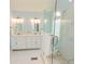 Bright bathroom featuring a double vanity with marble counters and a glass enclosed shower at 7030 Wessex Way, Cumming, GA 30028