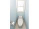 Cozy half bathroom with white toilet next to window at 7030 Wessex Way, Cumming, GA 30028