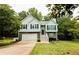 Charming two-story home with stone accents, a well-manicured lawn, and inviting staircase at 7030 Wessex Way, Cumming, GA 30028