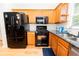 Modern kitchen with stainless steel appliances, wood cabinets, and granite countertops for cooking enjoyment at 7030 Wessex Way, Cumming, GA 30028