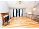 Open-concept living room with hardwood floors, fireplace, and large windows offering ample natural light at 7030 Wessex Way, Cumming, GA 30028