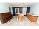 Living room featuring a piano, wet bar, and light blue paint at 7030 Wessex Way, Cumming, GA 30028