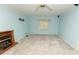 This living room features a cozy fireplace, neutral carpeting, and soft blue walls at 7030 Wessex Way, Cumming, GA 30028