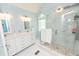 Light and airy main bathroom with double vanity and glass-enclosed shower at 7030 Wessex Way, Cumming, GA 30028