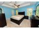 The spacious main bedroom is complete with a tray ceiling and a ceiling fan at 7030 Wessex Way, Cumming, GA 30028