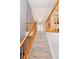 Carpeted stairs with wooden banisters lead to the upper level, complemented by neutral wall tones at 7030 Wessex Way, Cumming, GA 30028