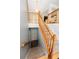 Staircase with wooden railing and carpet steps leading to the lower level of the home at 7030 Wessex Way, Cumming, GA 30028
