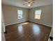 Bright bedroom featuring hardwood floors, a ceiling fan, and two windows at 1929 Hazelwood Se Dr, Marietta, GA 30067