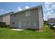 The level backyard features a well-maintained lawn and patio, enclosed by neighboring properties at 2504 Bear Mountain St, Lithonia, GA 30058
