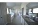 A luxurious bathroom with double vanities, tiled floors, and a separate shower and tub at 2504 Bear Mountain St, Lithonia, GA 30058