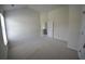 Spacious bedroom with neutral carpeting, a bright window and a doorway leading to the hall at 2504 Bear Mountain St, Lithonia, GA 30058