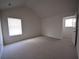 Large carpeted bedroom with a vaulted ceiling, and lots of natural light from the windows at 2504 Bear Mountain St, Lithonia, GA 30058