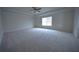 Spacious carpeted bedroom with modern ceiling fan and window for ample natural light at 2504 Bear Mountain St, Lithonia, GA 30058