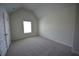 Comfortable bedroom with neutral carpet, bright window, and a white door at 2504 Bear Mountain St, Lithonia, GA 30058