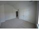 Cozy bedroom showcasing neutral carpet, and a double-door closet at 2504 Bear Mountain St, Lithonia, GA 30058