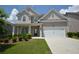 Charming two-story home with a manicured lawn, a two-car garage and covered front porch at 2504 Bear Mountain St, Lithonia, GA 30058