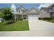 Inviting two-story home showcasing a well-kept lawn and a convenient two-car garage at 2504 Bear Mountain St, Lithonia, GA 30058