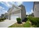 Side view of a two-story house showing the garage, driveway, and partial lawn at 2504 Bear Mountain St, Lithonia, GA 30058