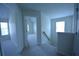 Hallway with plush carpeting that looks into a large bedroom with lots of natural light at 2504 Bear Mountain St, Lithonia, GA 30058