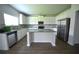 New kitchen with stainless steel appliances, granite countertops, and a large island at 2504 Bear Mountain St, Lithonia, GA 30058