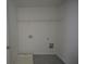 Functional laundry room with tile floor, shelving, and utility connections at 2504 Bear Mountain St, Lithonia, GA 30058
