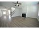 Open living room features hardwood flooring and a fireplace at 2504 Bear Mountain St, Lithonia, GA 30058