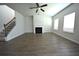 Spacious living room with fireplace, ceiling fan, and large windows at 2504 Bear Mountain St, Lithonia, GA 30058