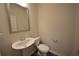 This powder room features a pedestal sink, wood-look floors, and a modern square mirror at 2504 Bear Mountain St, Lithonia, GA 30058