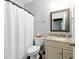 Bathroom features a shower with white curtain, granite countertop, and neutral decor at 312 Laurel Run Cv, Sugar Hill, GA 30518