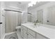 Bright bathroom featuring a vanity, ample counter space, and a shower curtain at 312 Laurel Run Cv, Sugar Hill, GA 30518