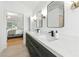 Bright bathroom featuring a double vanity and a window for natural light at 312 Laurel Run Cv, Sugar Hill, GA 30518