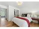 Comfortable bedroom featuring a closet, natural light, and hardwood floors at 312 Laurel Run Cv, Sugar Hill, GA 30518