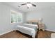 Cozy bedroom with a ceiling fan and a large window offering natural light at 312 Laurel Run Cv, Sugar Hill, GA 30518