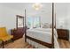 Bright bedroom featuring a bed, natural light, and hardwood floors at 312 Laurel Run Cv, Sugar Hill, GA 30518