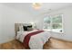Cozy bedroom featuring a comfortable bed, natural light, and hardwood floors at 312 Laurel Run Cv, Sugar Hill, GA 30518