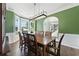 Dining room showcasing a long table, wooden chairs, and large windows providing lots of natural light at 312 Laurel Run Cv, Sugar Hill, GA 30518