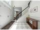 Bright foyer with a patterned tile floor, staircase, and decorative console table at 312 Laurel Run Cv, Sugar Hill, GA 30518