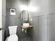 Modern half bathroom features gray walls, a stylish round sink, and a sleek, minimalist design at 312 Laurel Run Cv, Sugar Hill, GA 30518